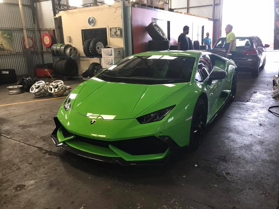 A green sports car inside the Tyre Select workshop.